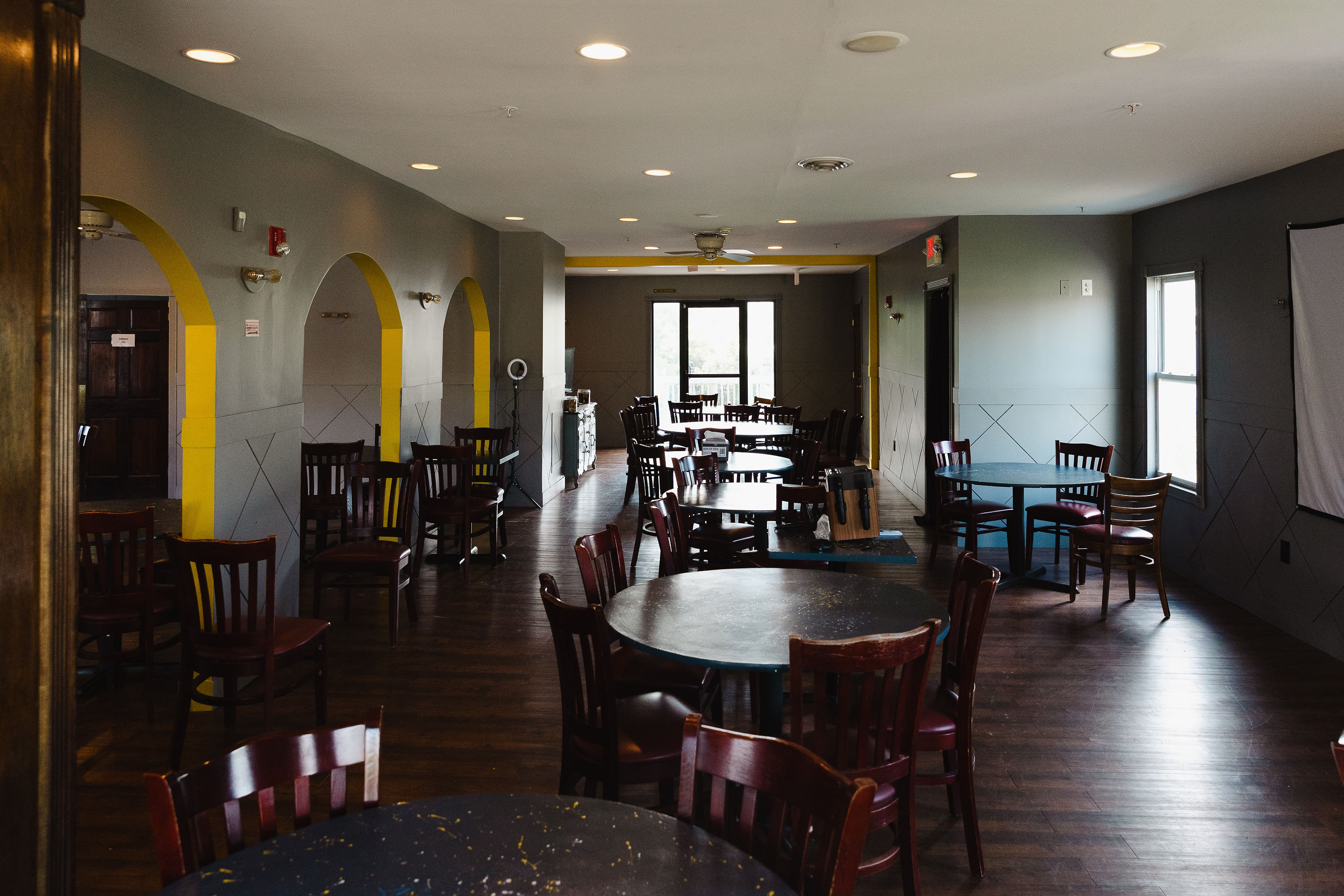 Event room with signature yellow arches and round tables
