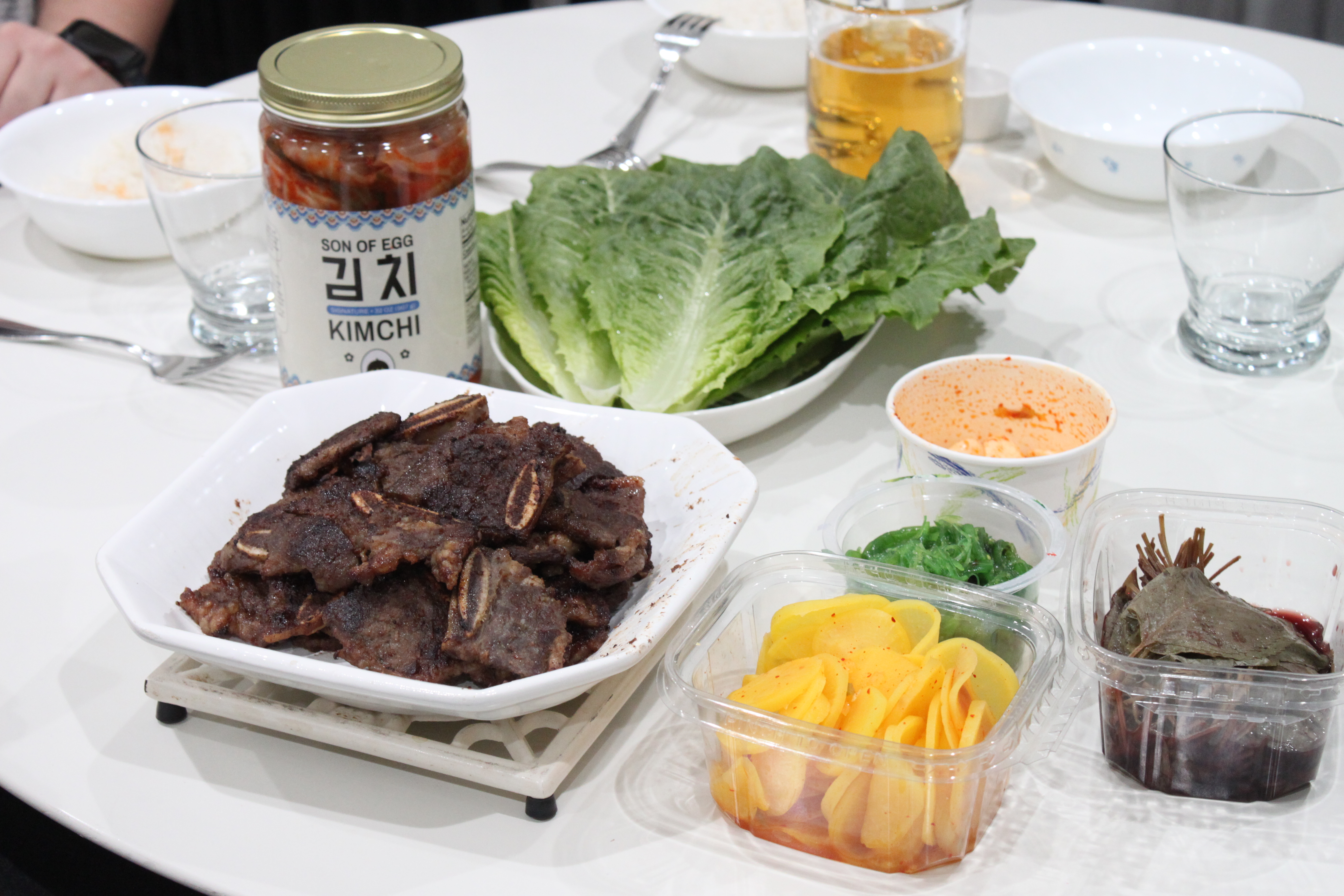 Son of Egg catering spread with kalbi, lettuce wraps, banchan, and kimchi